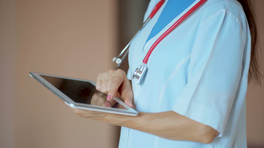 Woman doctor using tablet computer in hospital Royalty-Free Stock Footage #1016448895