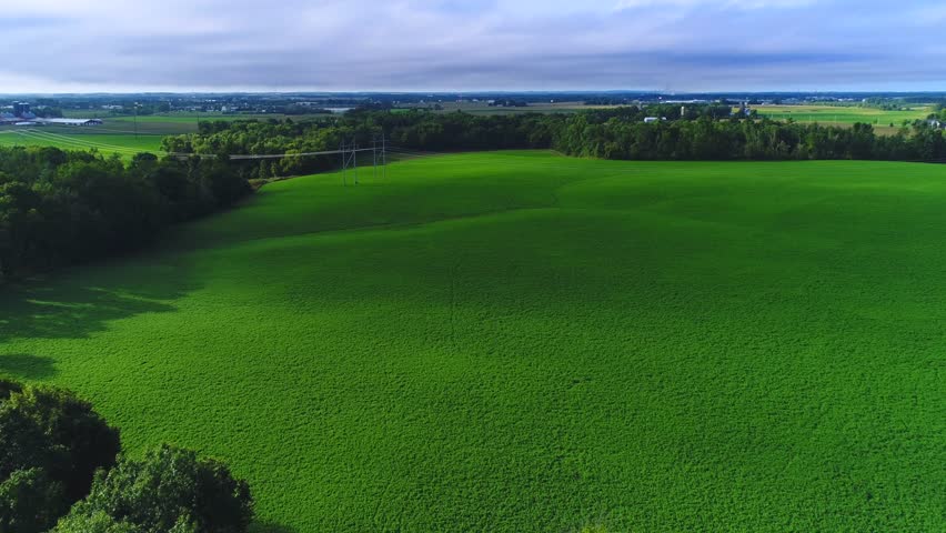 Time Lapse flyover of lush rural Wisconsin Landscape with moving cloud shadows.
