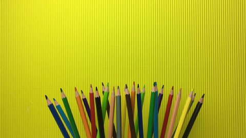 Coloured Pencils On Yellow Background Stock Footage Video (100% Royalty