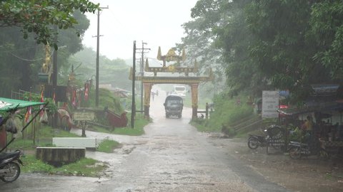 Heavy thunderstorm with rain wind bending trees in residential area at Bago, Myanmar