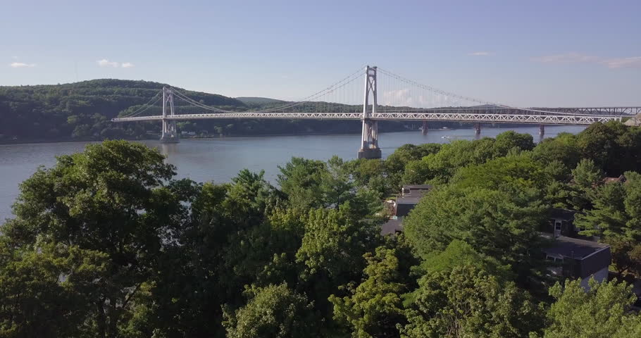 Drone move up from tree to reveal Hudson river and bridge | Shutterstock HD Video #1016463244