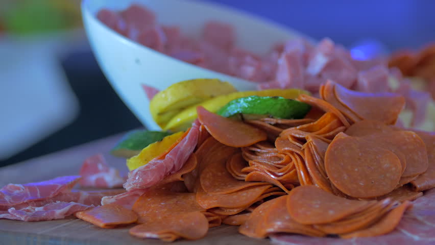 Pepperoni in front of other meats close pan