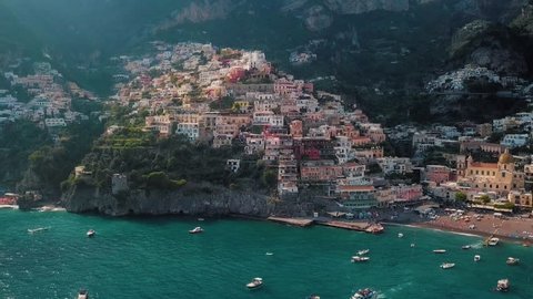 A captivating aerial view of the cliffside living and luxury boats on the seaside.