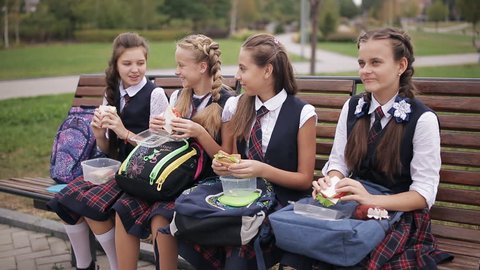 College Students On Bench Park Eating Stock Footage Video (100% Royalty ...