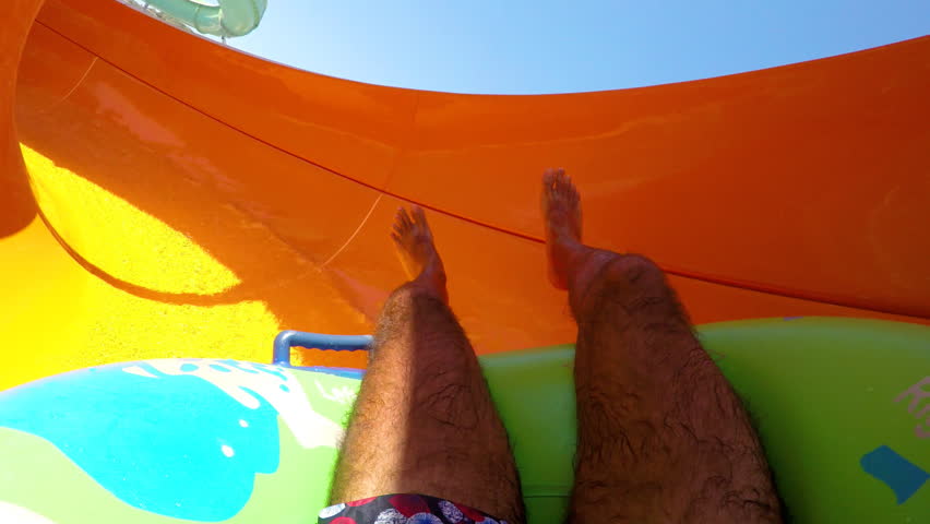 Man enjoying water slide in aqua park