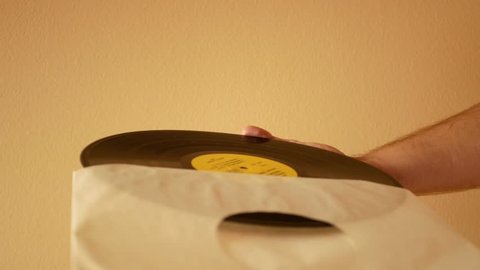 Remove vinyl record from paper sleeve