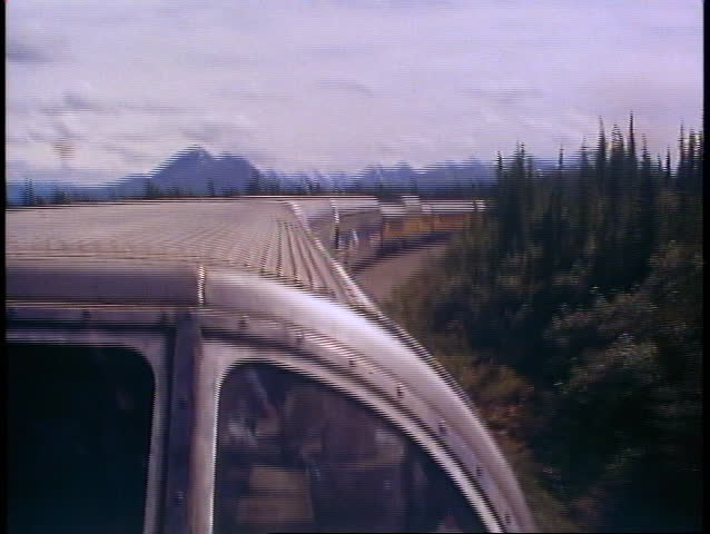 ALASKA RAILROAD, 1989, POV from dome car of scenery, train ahead in curve