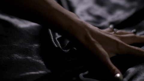 Hand grabbing sheet, sex concept