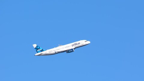 NEW YORK - 2018: JetBlue Airways Airbus A320-200 Commercial Jet Airplane Flying in a Clear Blue Sky after Taking Off from JFK International Airport