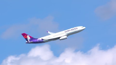 NEW YORK - 2018: Hawaiian Airlines Airbus A330-200 Commercial Jet Airplane Taking Off Flying into a Blue Sky with Clouds after Taking Off from JFK International Airport Enroute to Honolulu