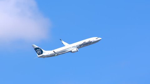 NEW YORK - 2018: Alaska Airlines Boeing 737-900 Commercial Jet Airplane Flying in a Clear Blue Sky after Taking Off from JFK International Airport