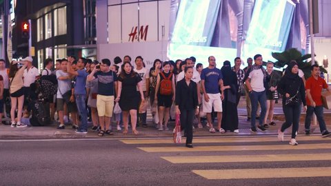 Kuala Lumpur, Malaysia - 17 September 2018. Busy Kuala Lumpur pedestrian crossing street at peak hour. Malaysia is one of the best shopping destination.