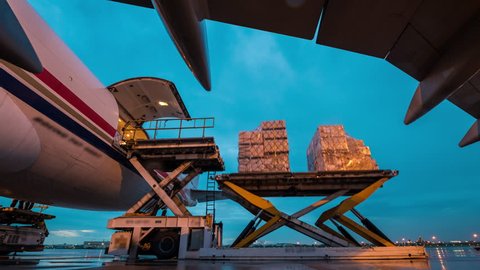 Air cargo freighter with import and export at twilight sky - Time lapse