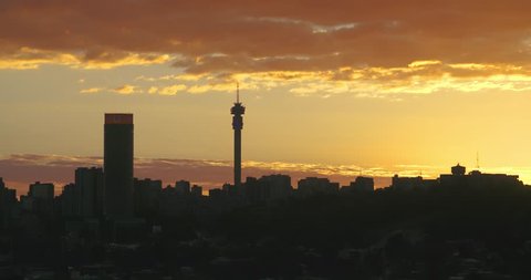 Magnificent Johannesburg / Joburg sunset with golden clouds and vista of the city.