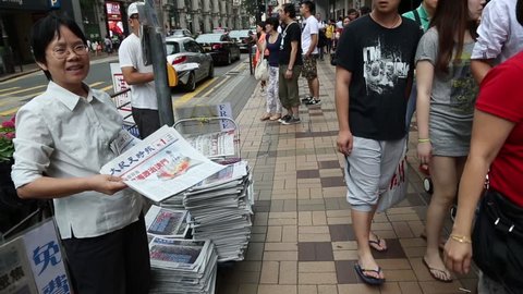 HONG KONG - CIRCA JUNE, 2014: Sellers of newspapers on the streets of Hong Kong in the Tsim Sha Tsui district at the Kowloon Peninsula.
