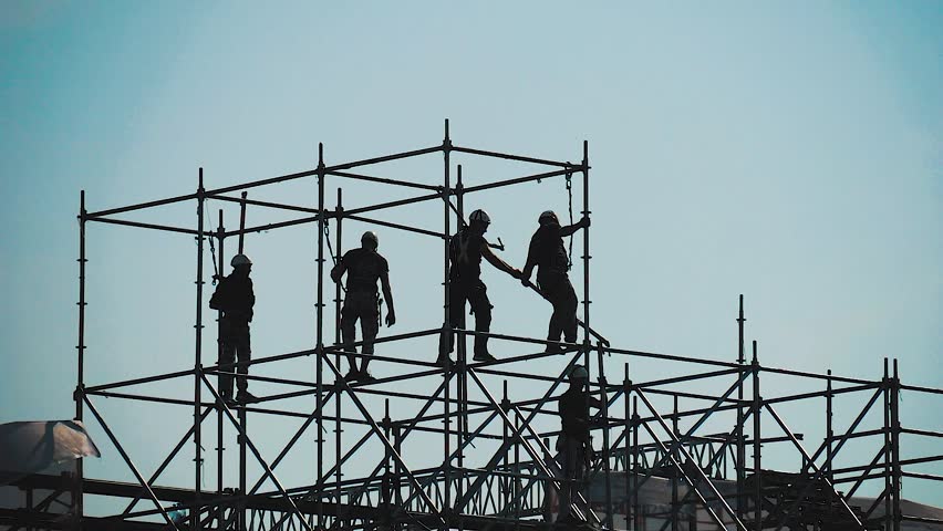 Silhouettes of construction workers. Silhouettes mens engineers construction site construction worker on construction site.