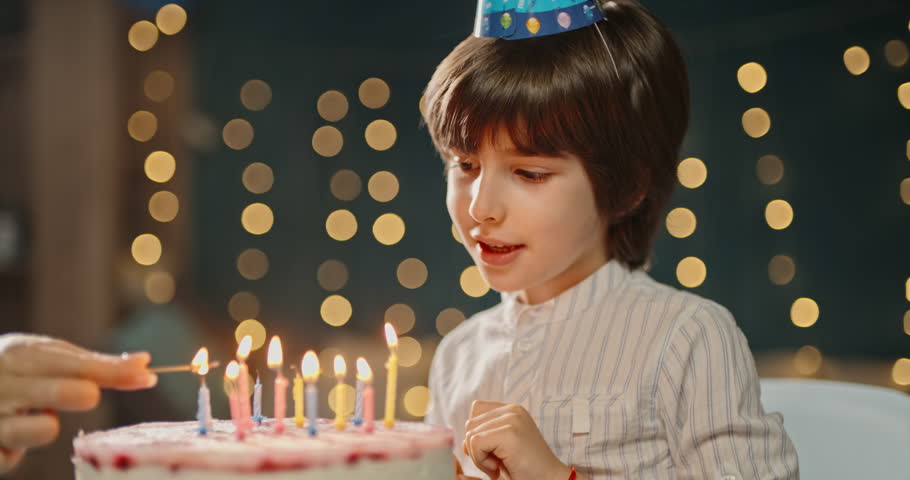 Kid having birthday. Little child having a party with birthday cake, ready to blow out the candles, making a wish - happy childhood concept 4k