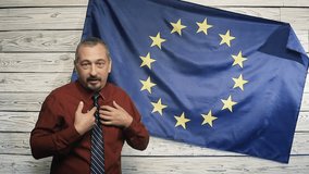 Politician on the background of the EU flag says it