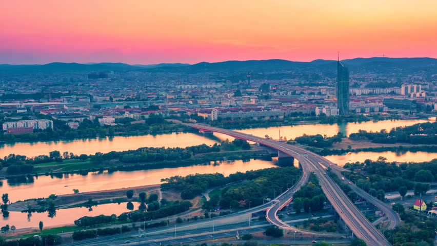 Vienna, Austria cityscape with skyline and with a Danube panorama at sunset. Time lapse. Zoom out effect