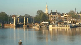 Morning view of the historical Montelbaanstoren Tower and cityscape at Amsterdam, Netherlands