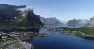Lofoten aerial footage. Norway, flying above traditional red wooden houses. Camera moves forward. 