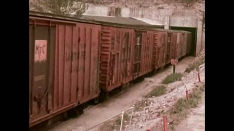 CIRCA -1964 - Crates of food are loaded onto rail cars in an underground facility; others are put into massive cold storage units, also underground.