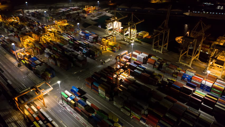 Aerial hyperlapse - Night shot of busy industrial port. Footage of seamless transport routes supply chain Royalty-Free Stock Footage #1016530066