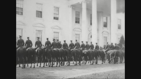 CIRCA 1920s - Marshal Ferdinand Foch steps out of a car at the White House and mounted troops are shown in Washington, D.C.