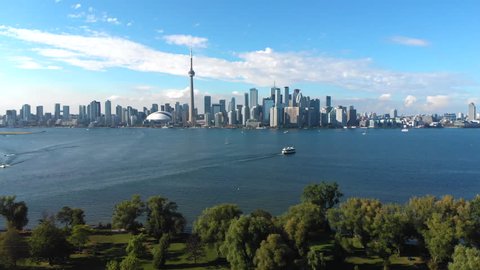 Aerial view of Toronto skyline, Centre Island and Lake Ontario on a summer day in Toronto, Ontario, Canada, tilt up.