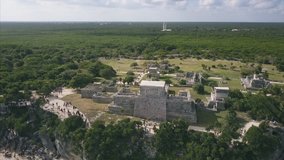4K Epic Aerial shot of Tulum Ancient Ruins Castle Mexico beach flying over water
