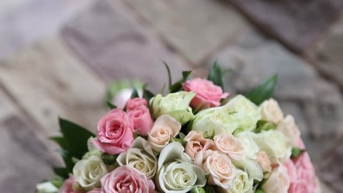 A wonderful wedding bouquet. Wedding rings near the bouquet. Flowers at the wedding.