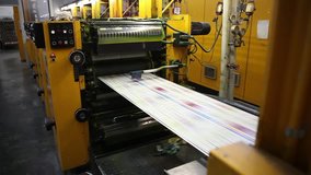 Video clip from the printing factory. Kilometers of newspapers. Printing machines in operation.