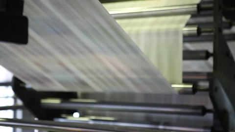 Video clip from the printing factory. Kilometers of newspapers. Printing machines in operation.