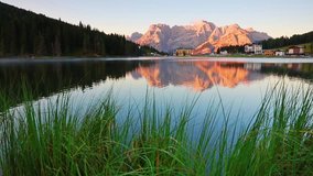 Stunning summer sunrise on Misurina lake. Wonderful morning scene of National Park Tre Cime di Lavaredo, Misurina resort, Dolomiti Alps, South Tyrol, Italy, Europe. Full HD video (High Definition).