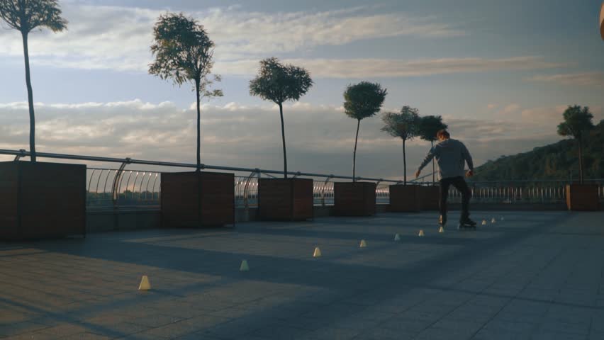 cool man on roller skates dancing sunrise slow motion