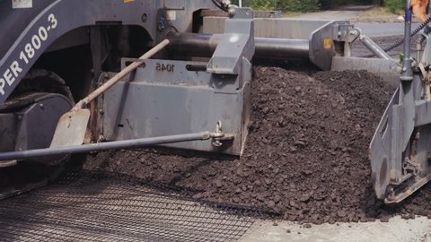 asphalt paving machine works, road construction crew apply asphalt layer