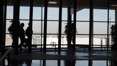 A lot of people passengers -travellers silhouette in the airport