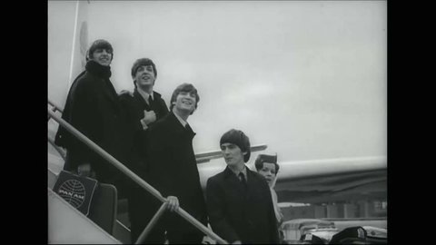 CIRCA 1964 - The Beatles are surrounded by screaming fans when they arrive at JFK, and as they tour Central Park.