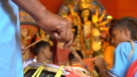KOLKATA, INDIA -SEPTEMBER 27, 2017 : Dhaakis (drummers) performing while hindu brahmin priests worshipping Durga - called "aarti", Durga Puja ritual. Biggest festival of Hinduism and Bengalis. 4K.