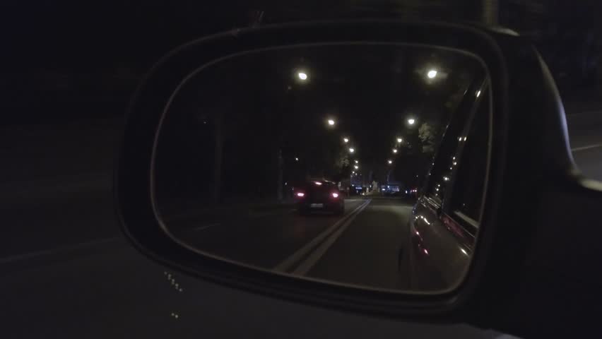 mirror of car driving on a night city road
 Royalty-Free Stock Footage #1016575336