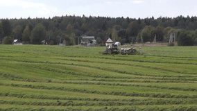 farm truck truck mowing grass on a meadow in the autumn season