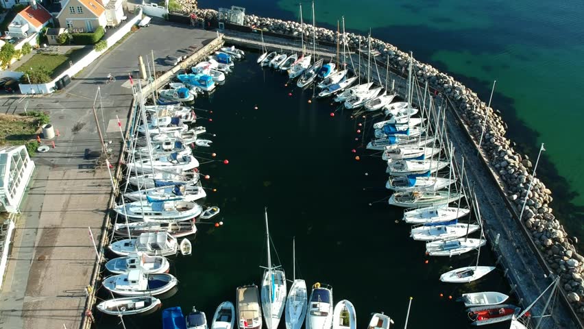 Aerial shot of a luxury marina with crystal clear blue water | Shutterstock HD Video #1016592169