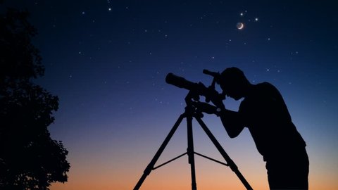 Man looking at stars and Moon through a telescope. My astronomy work.