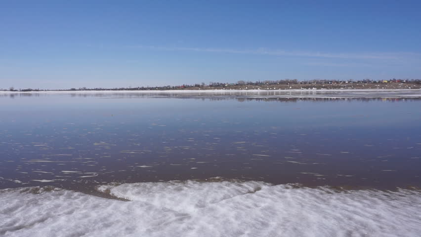 fisherman drags white fish on the river from the ice .