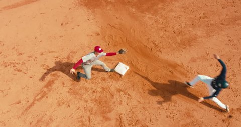 OVERHEAD CRANE Base runner attempts to touch a base during a baseball game. 4K UHD 60 FPS SLO MO RAW
