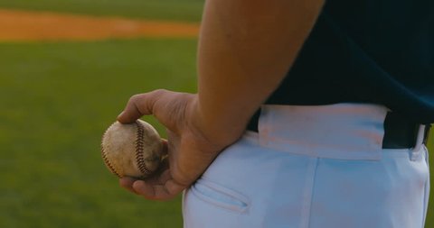 CU Pitcher baseball player prepares to throw a ball from the pitcher's mound. 4K UHD 