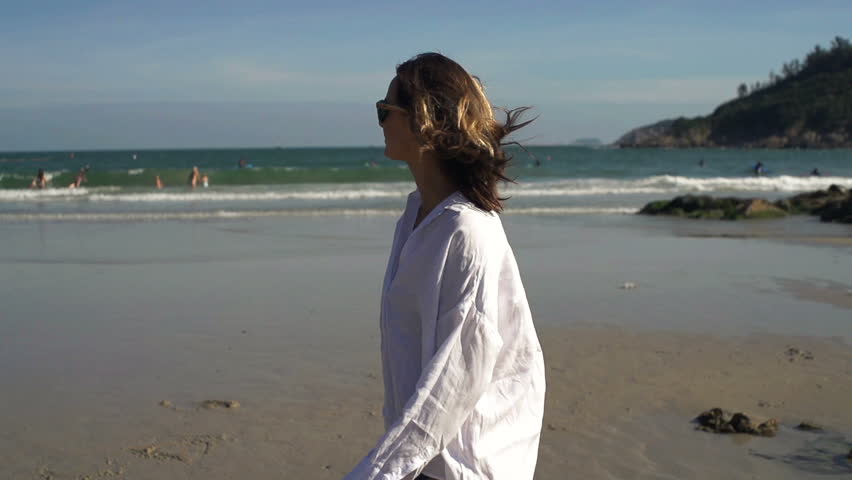 Young happy sexy woman walking on the beach, super slow motion 240fps
