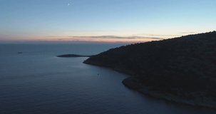 Beautiful aerial video of dusk evening in Dalmatia, Croatia.. Nice nature and landscape on summer sunset at Adriatic Sea and coast. Lovely seascape and outdoors shoot with drone from above in sky.