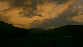 Motion video of  time lapse sunrise and cloud movement over the green paddy field / rice field fram in the morning at countryside in Chiangmai, Thailand