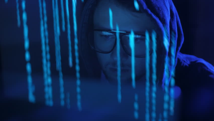 Close up of generation z hacker in glasses and hoodie working on computer under the blue neon light sparkle. Darkness background. Cybersecurity concept. ProRes 422 Royalty-Free Stock Footage #1016625325